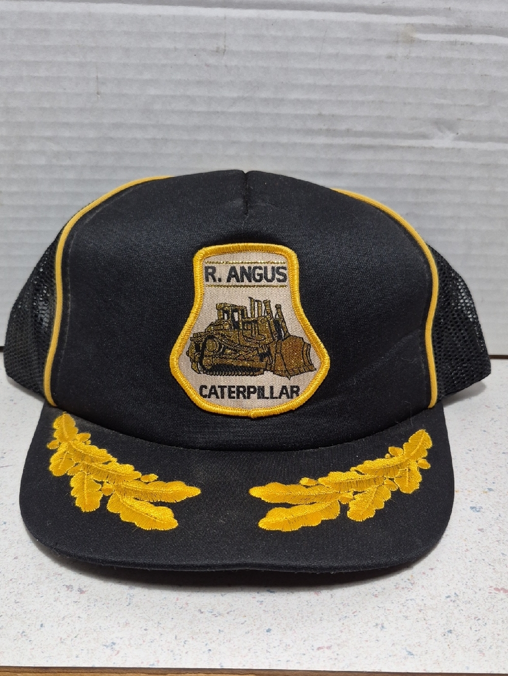 Caterpillar Black and Yellow Embroidered Patch Trucker Hat R. ANGUS